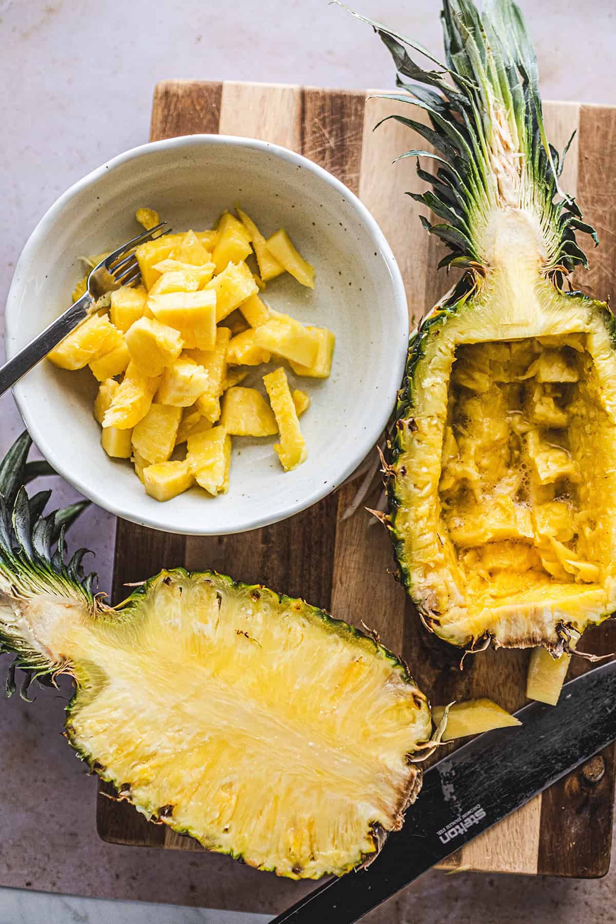 Chopped pineapple chunks in a bowl for fried rice.