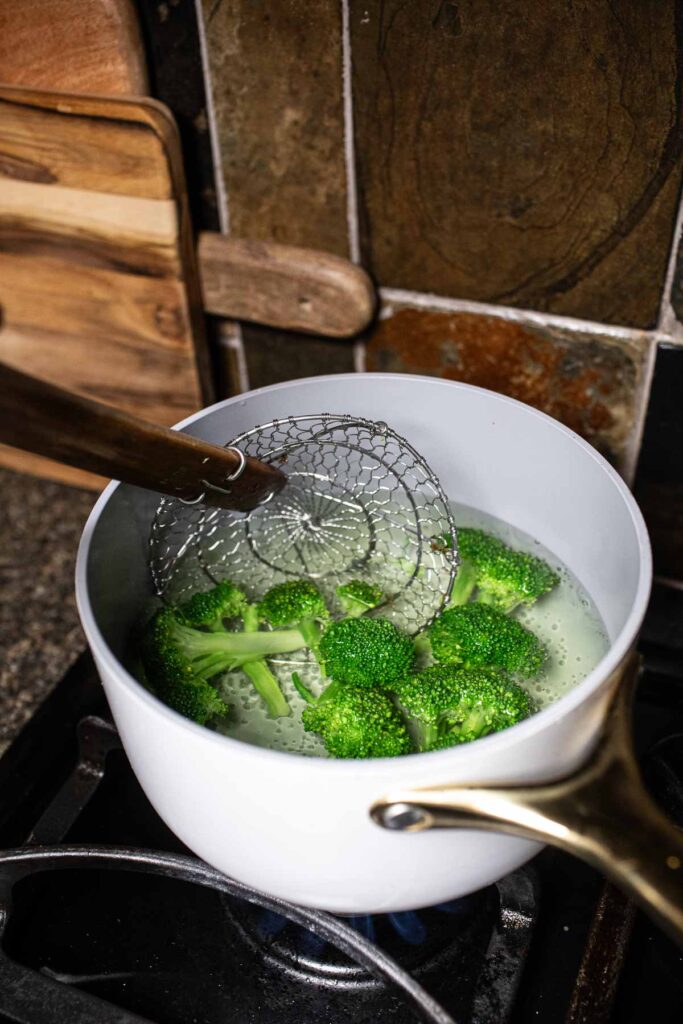 Blanching brocoli in a soup pot.