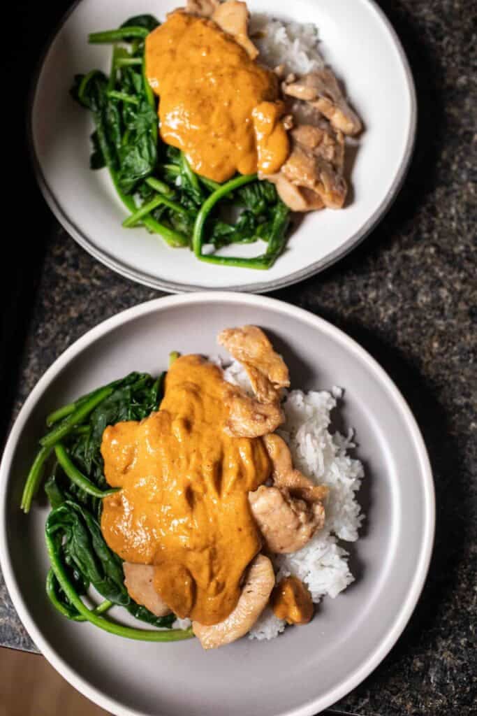 rama sauce over chicken and rice and spinach. 