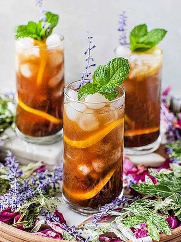 3 glasses of tamarind tea in a tray.