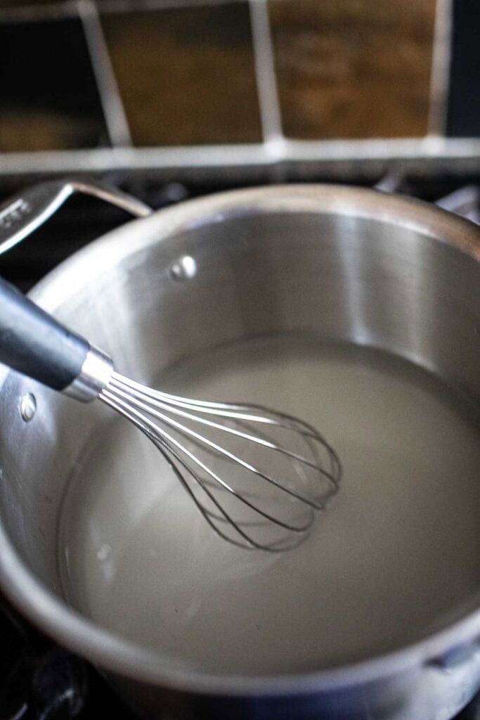 whisk in a pot with sugar water. 