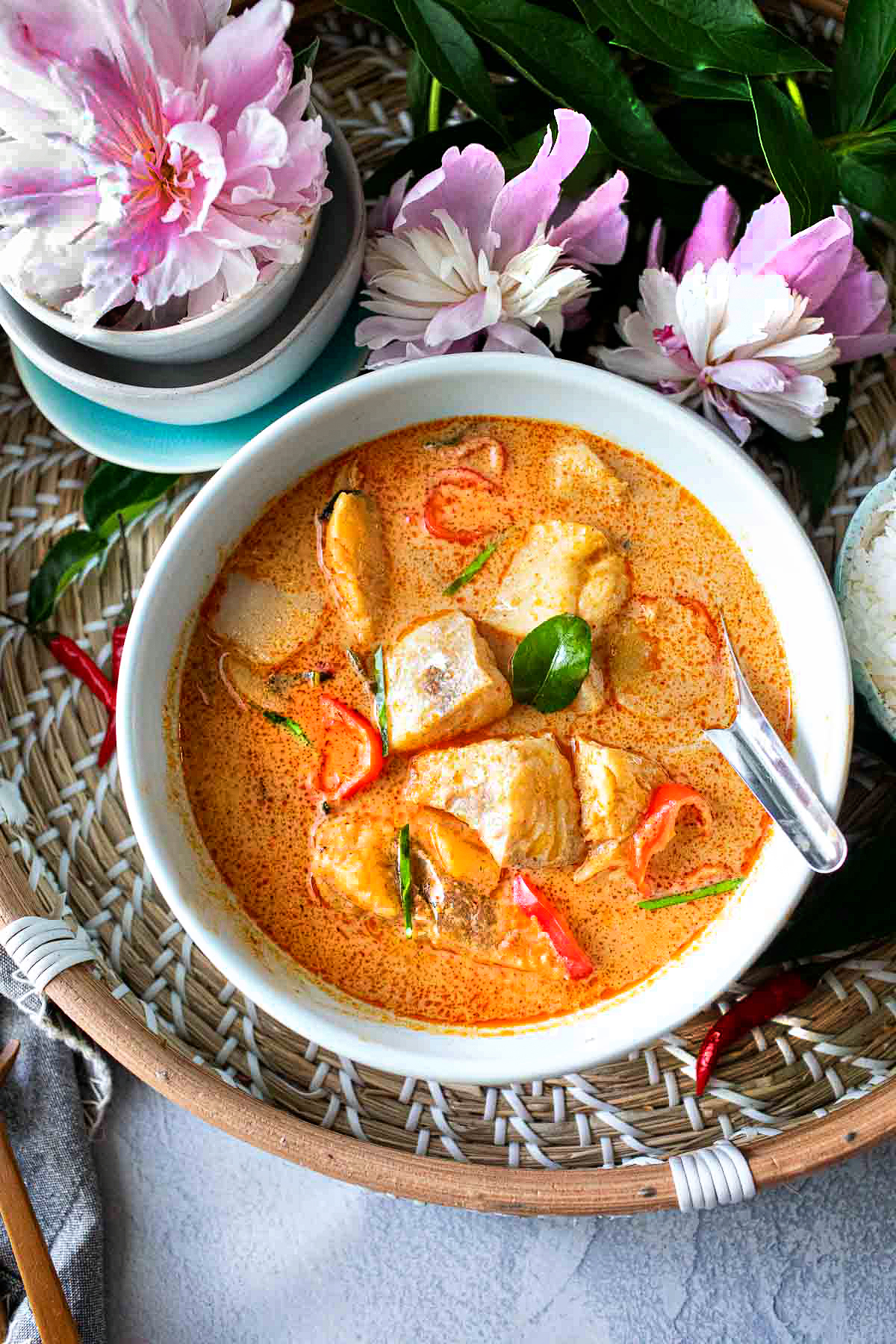 Thai fish red curry recipe in a bowl in a tray.