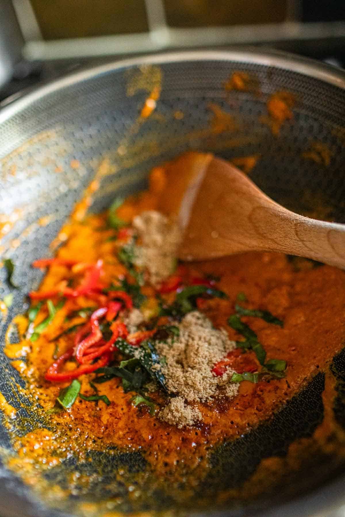 Thai red curry paste in a wok.