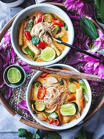 Thai vegetarian red curry in 2 bowls on a table.