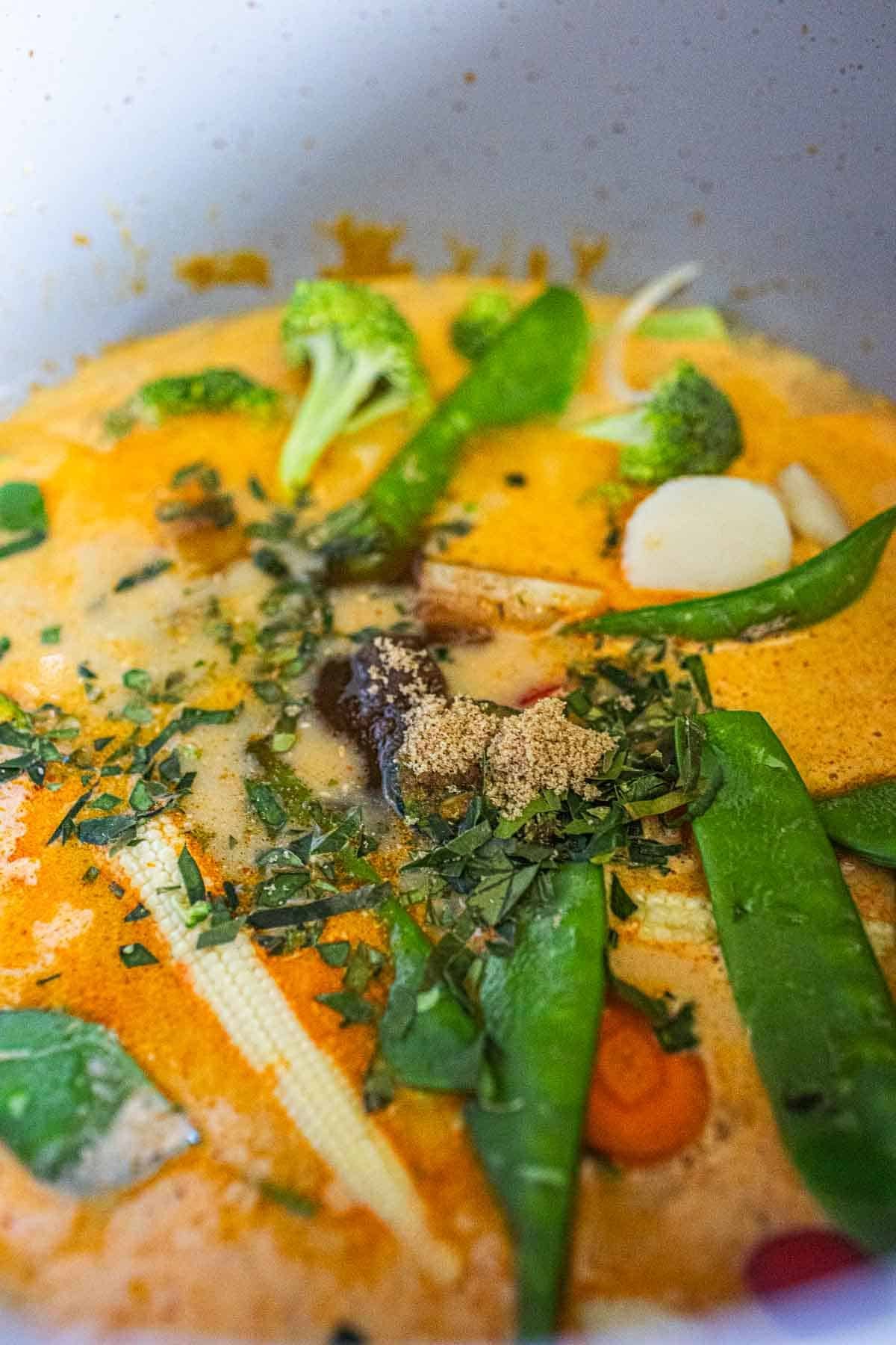 Red curry with vegetables in a pot. 