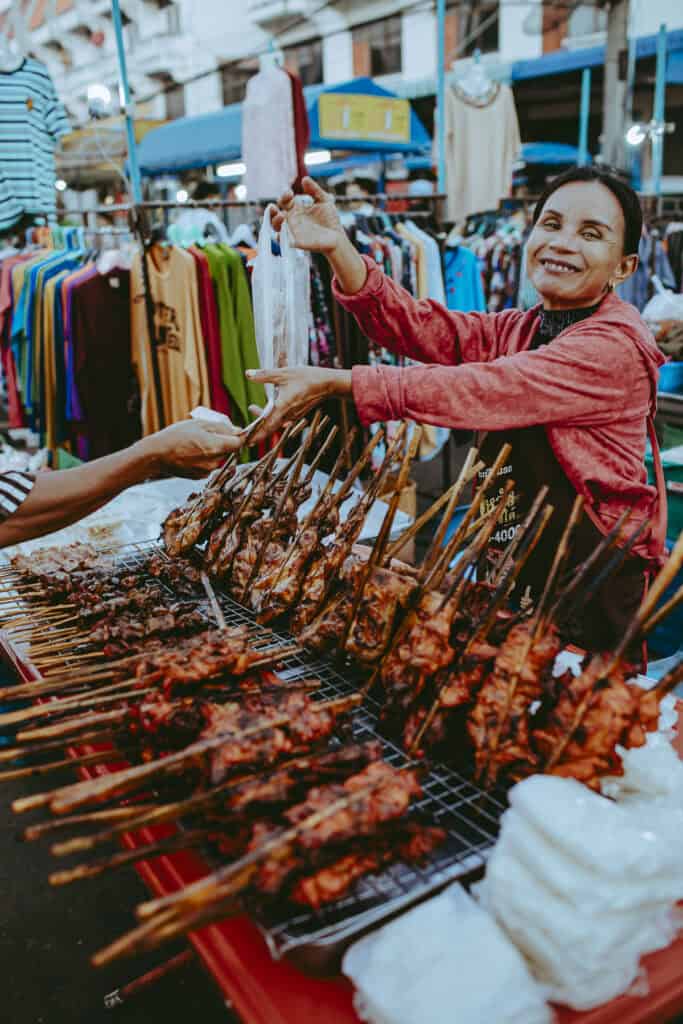 Gai Yang as Thai Street food with a thai vendor selling.