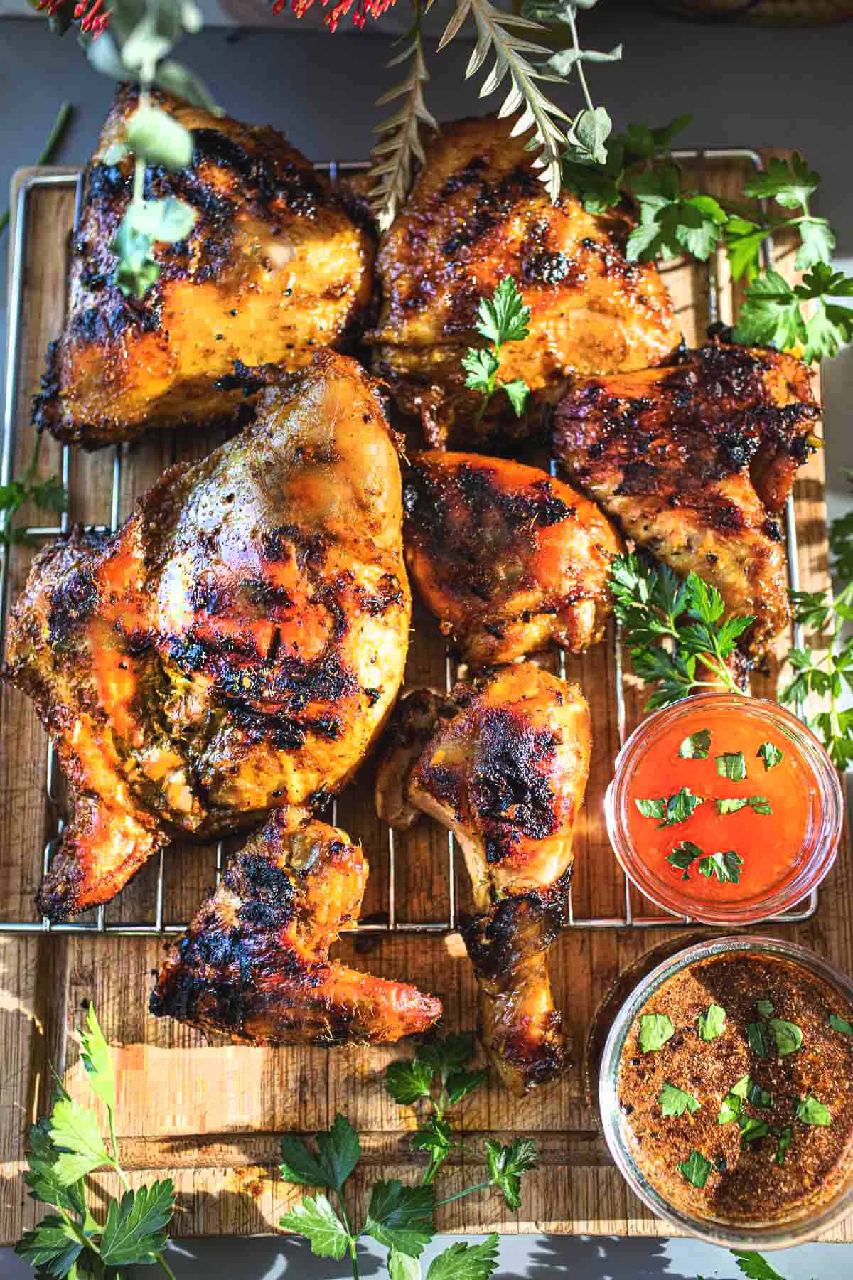 Gai Yang chicken on a rack with dipping sauce. 