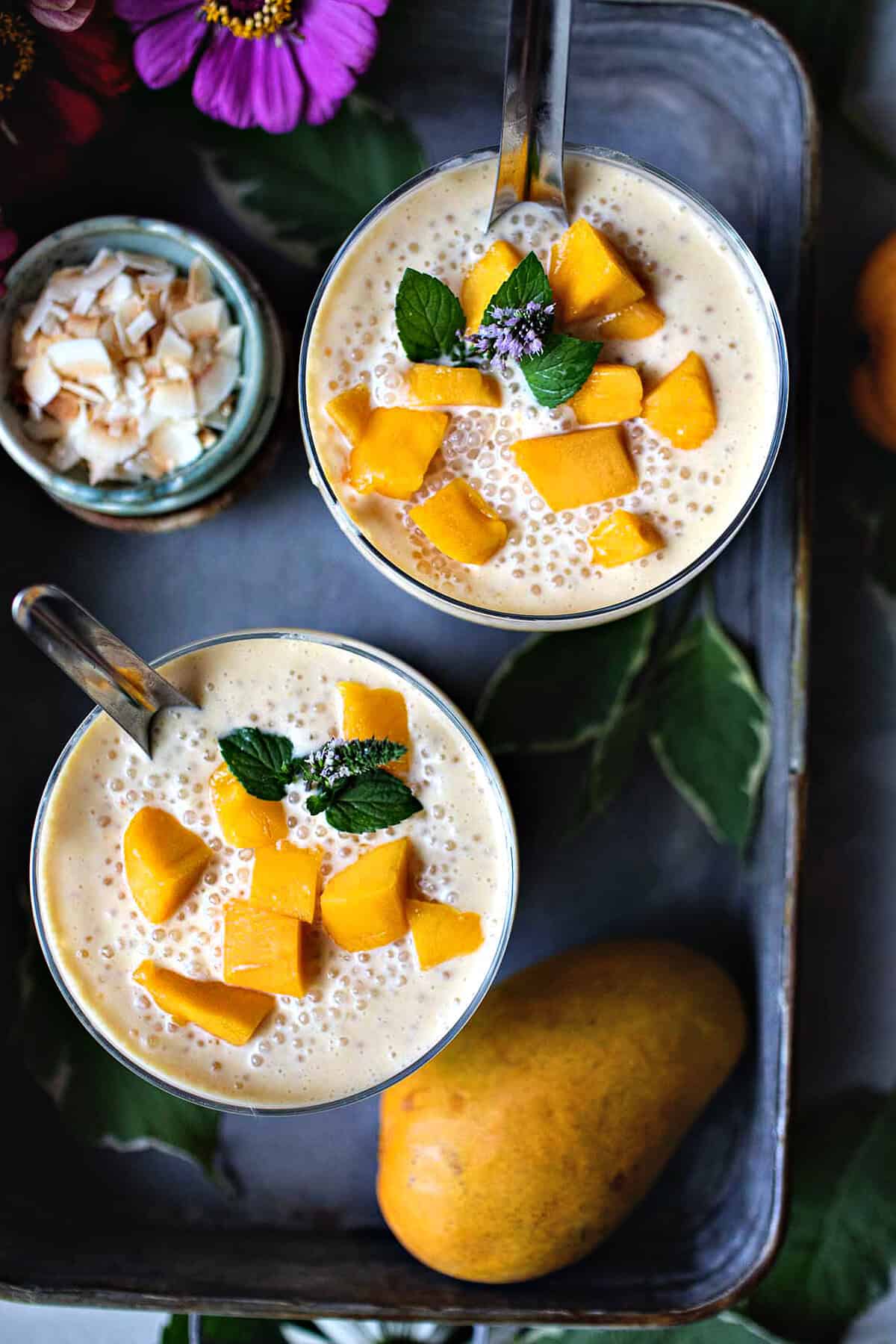 Mango Sago in glasses with mango slices and mint garnish.