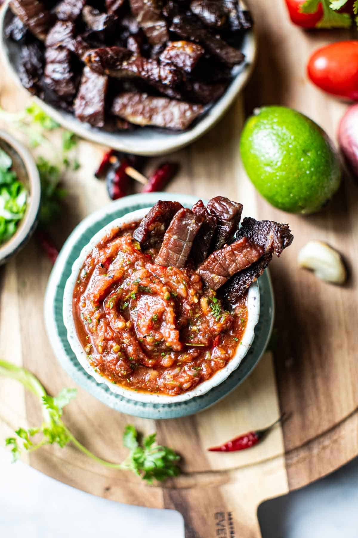 Thai Beef jerky dipped in a sauce.