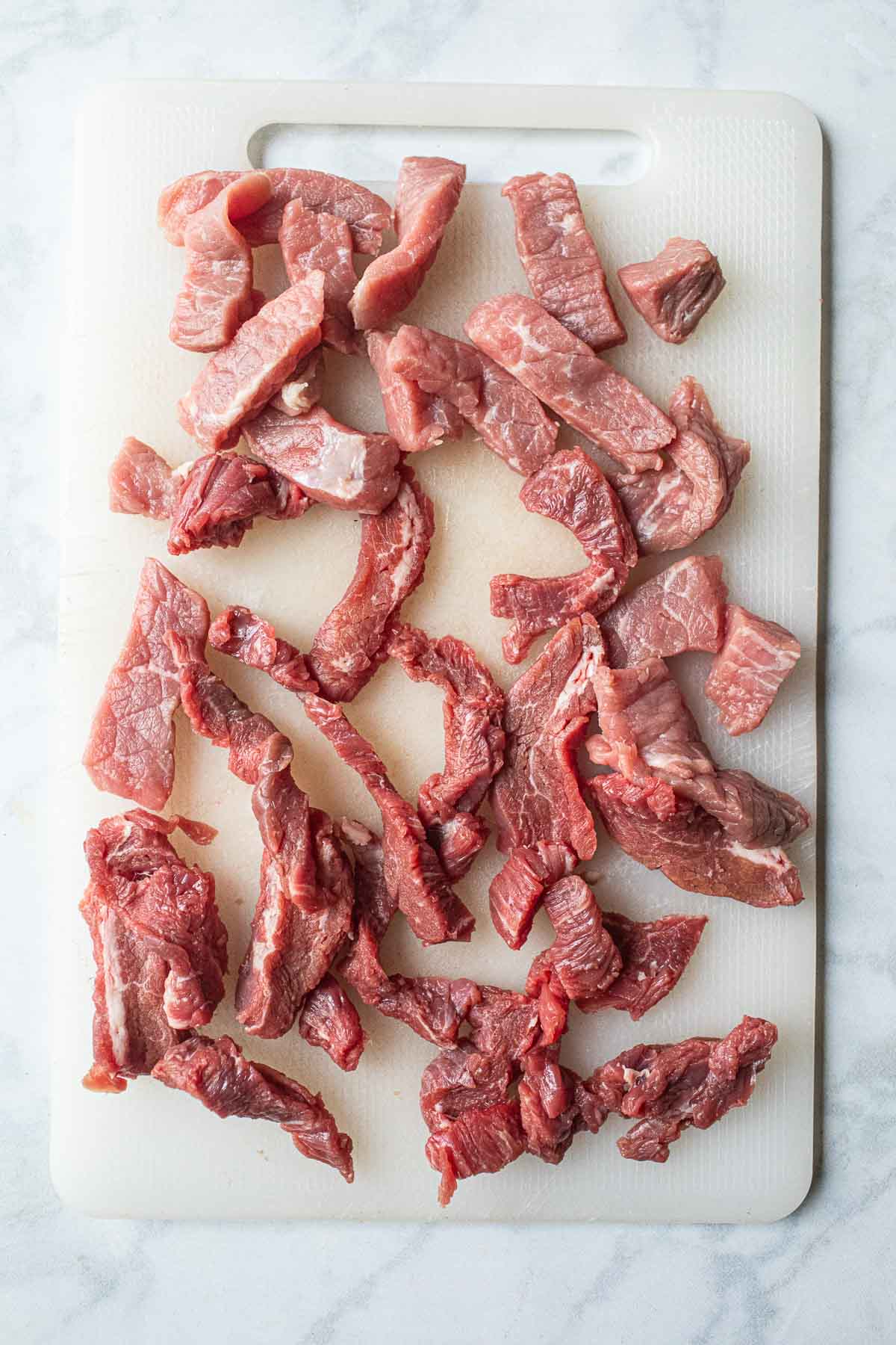 Beef slices on a cutting board. 