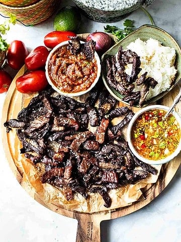 Thai beef jerky on a cutting board.