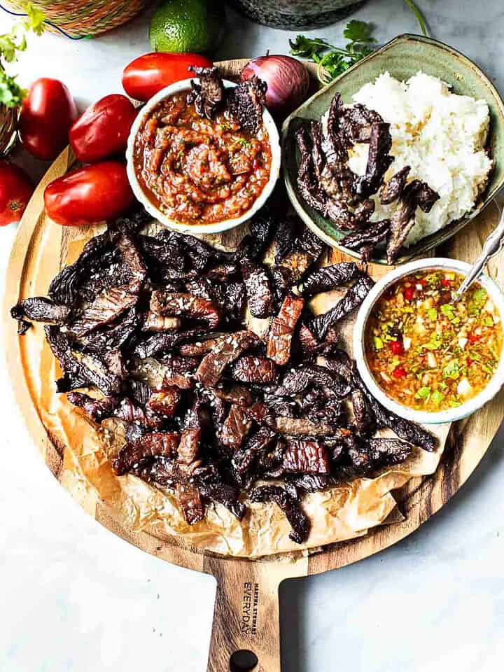 Thai beef jerky on a cutting board.