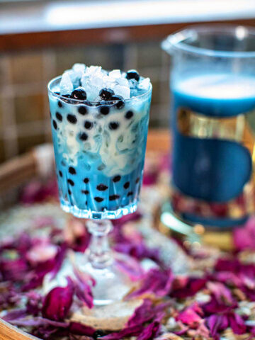 Butterfly blue milk tea in a glass.