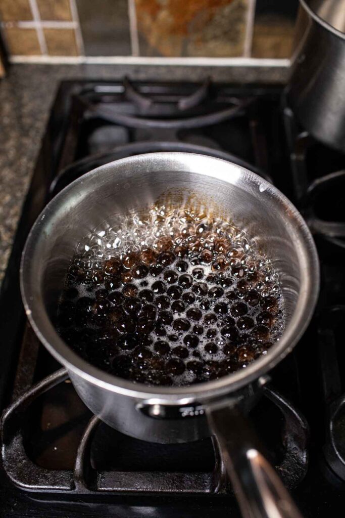 Cooking tapioca black pearls in a pot. 