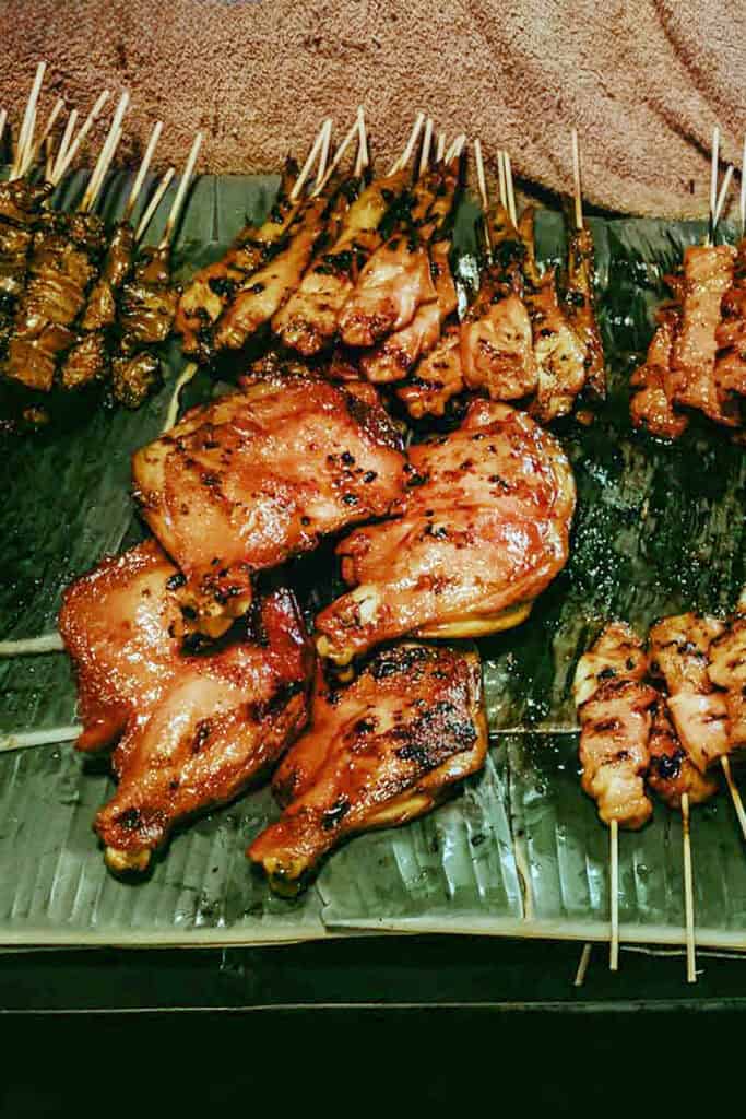 Gai Yang on sticks over banana leaves.
