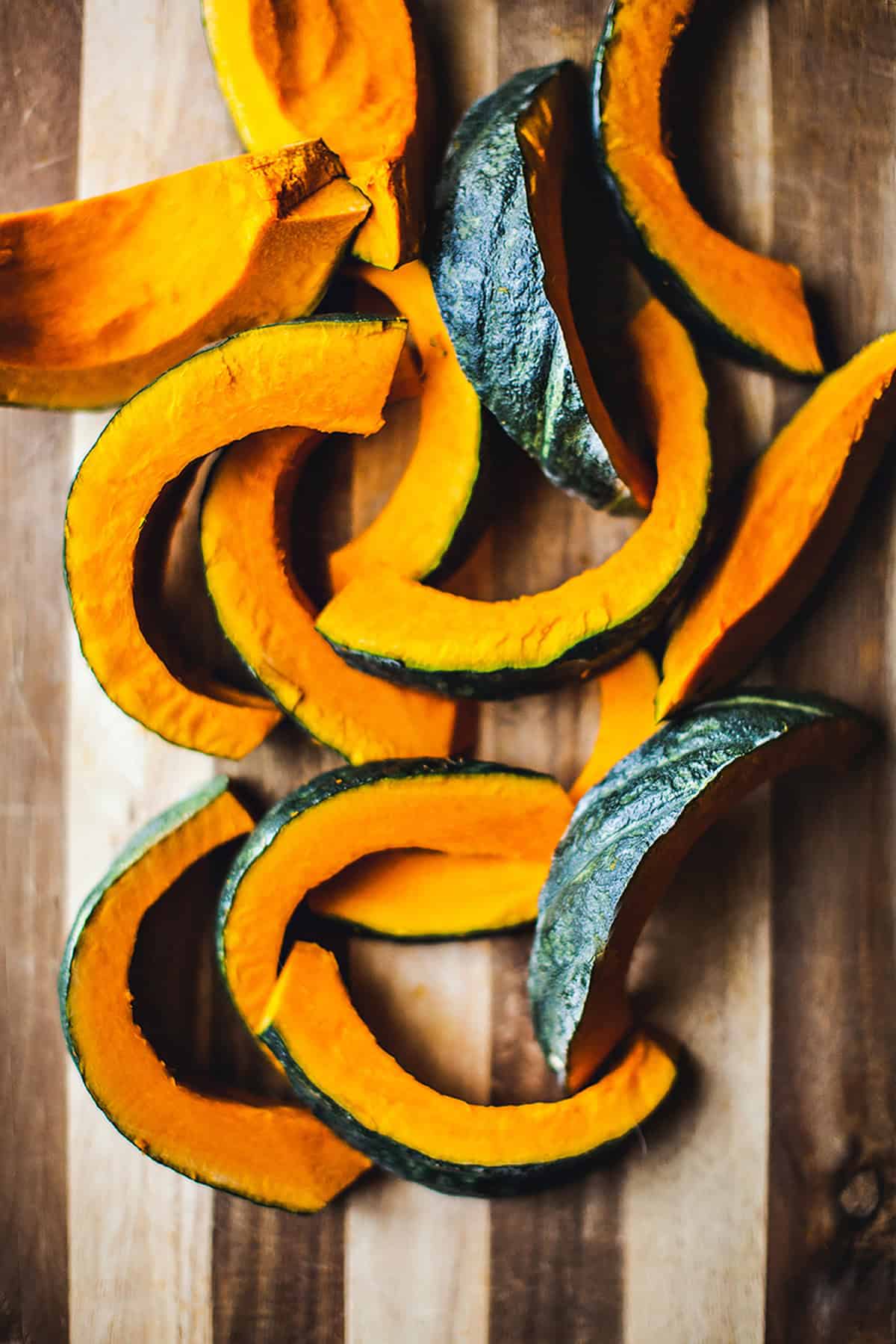 Sliced Kabocha squash on a cutting board.