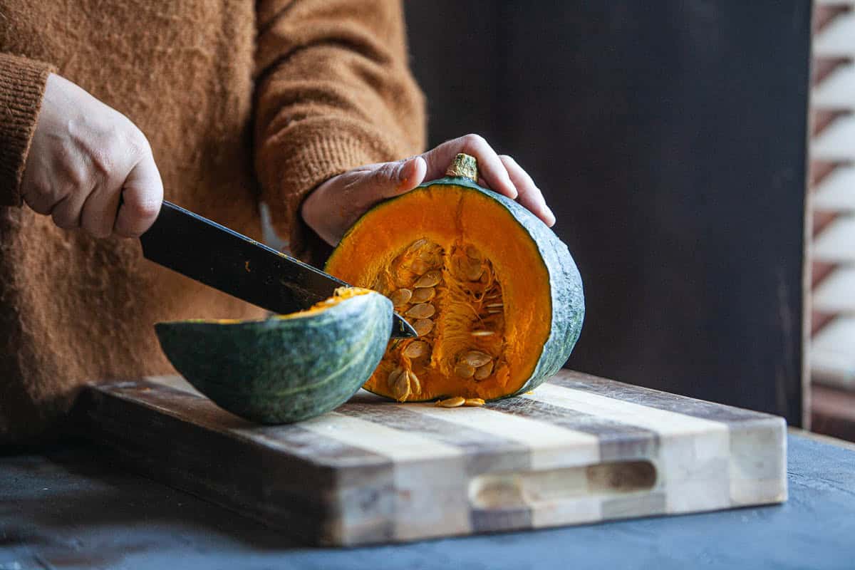 Cutting kabocha squash with a knife.