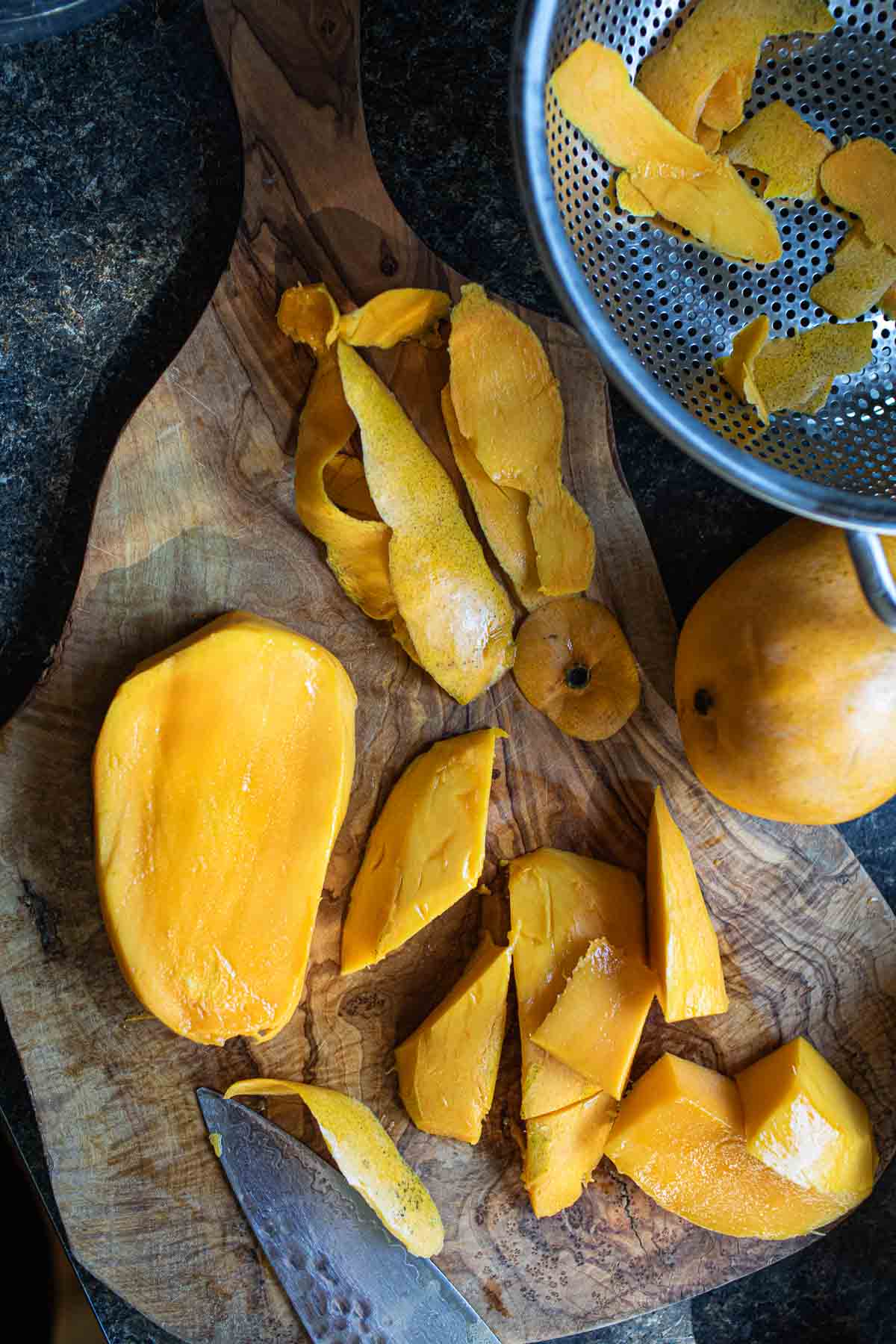 Mango slices on a cutting board. 