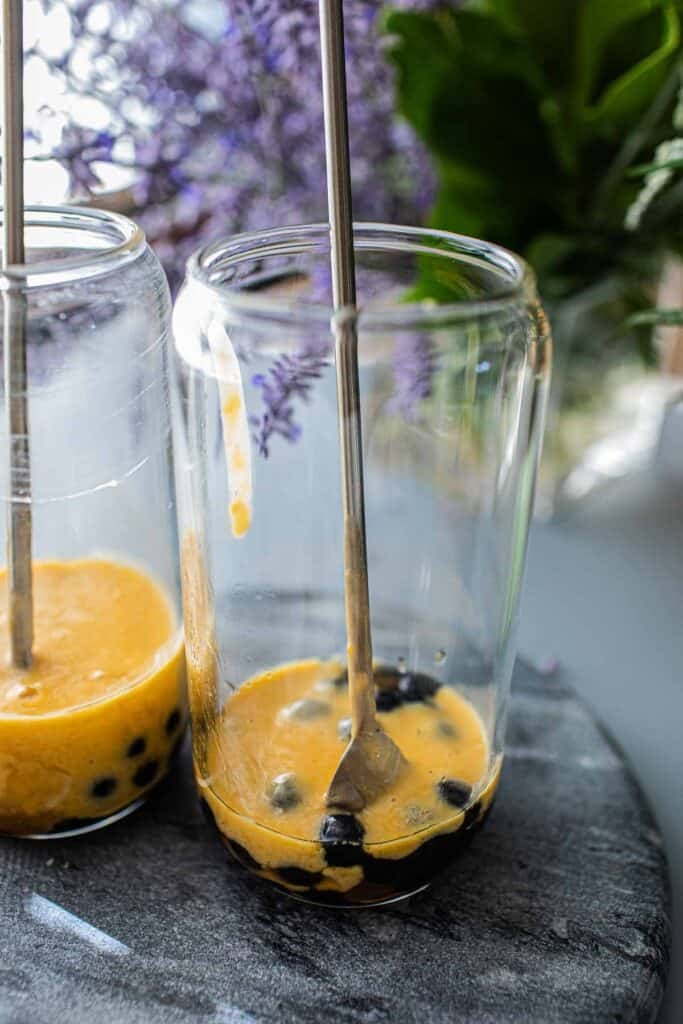 Mango tapioca pearls in a glass on table. 