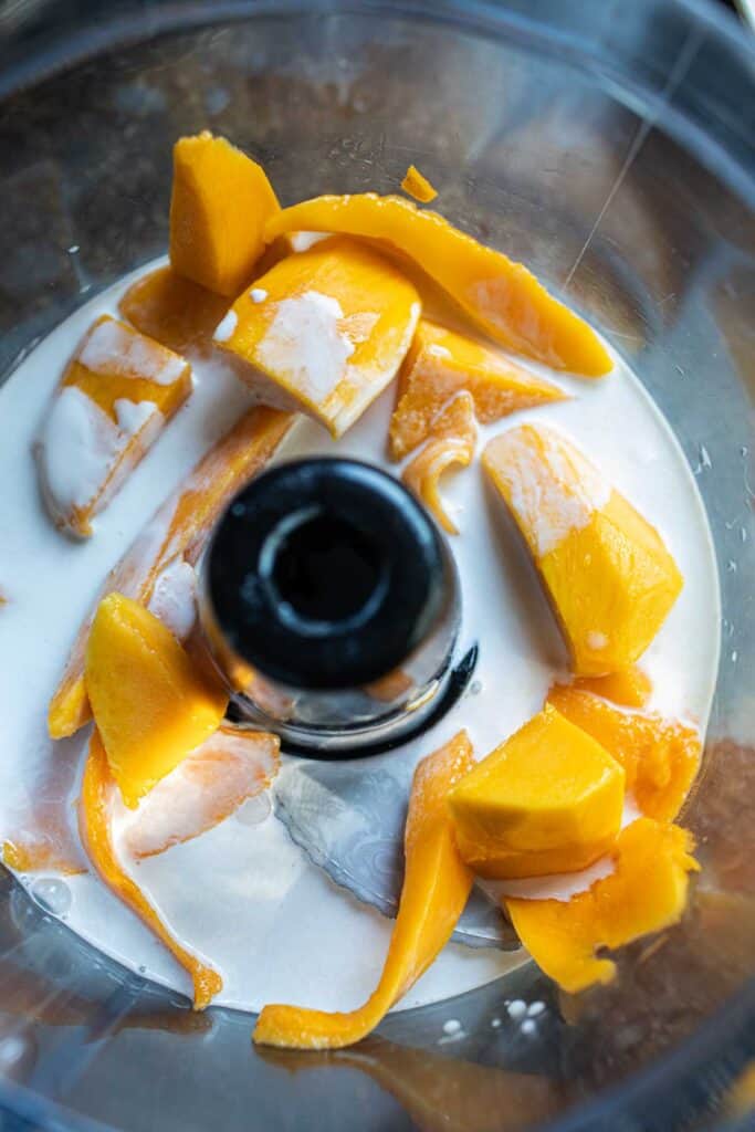 Mango and milk in a  blender. 