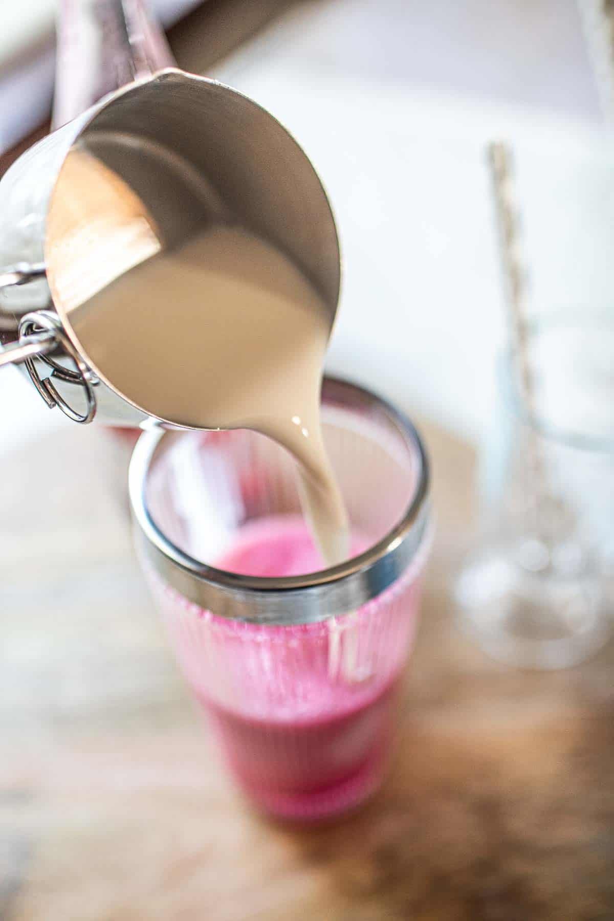 Evaporated milk pouring into a glass. 