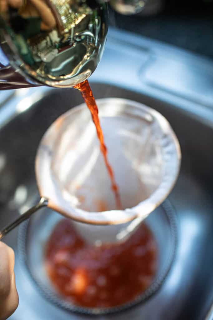 Pouring Thai ice tea in a glass bowl. 