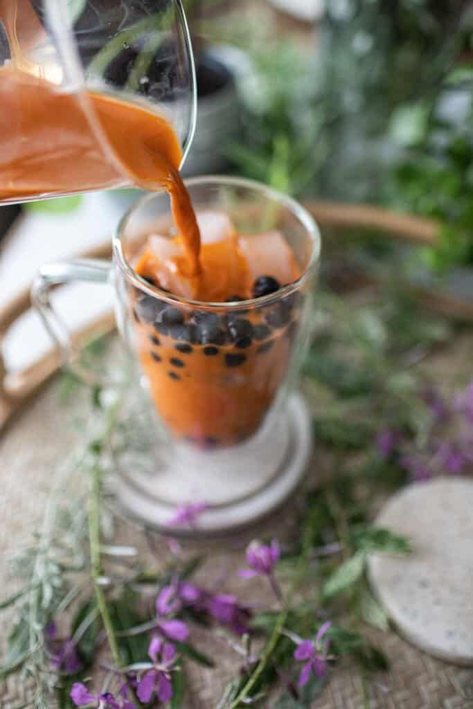 Pouring Thai Boba tea into a glass. 