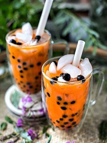 Thai tea boba in a glass on a tray.