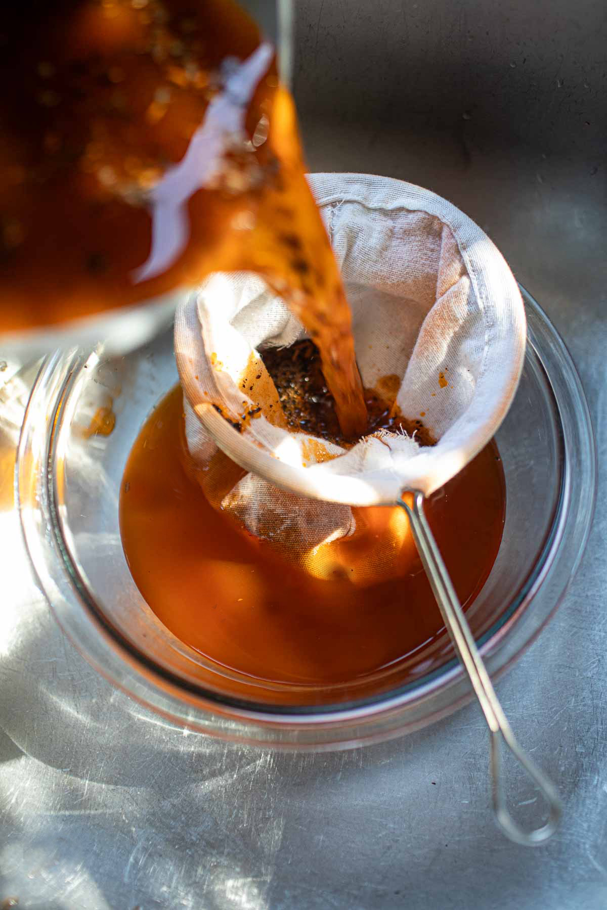 Thai tea pouring into a glass. 