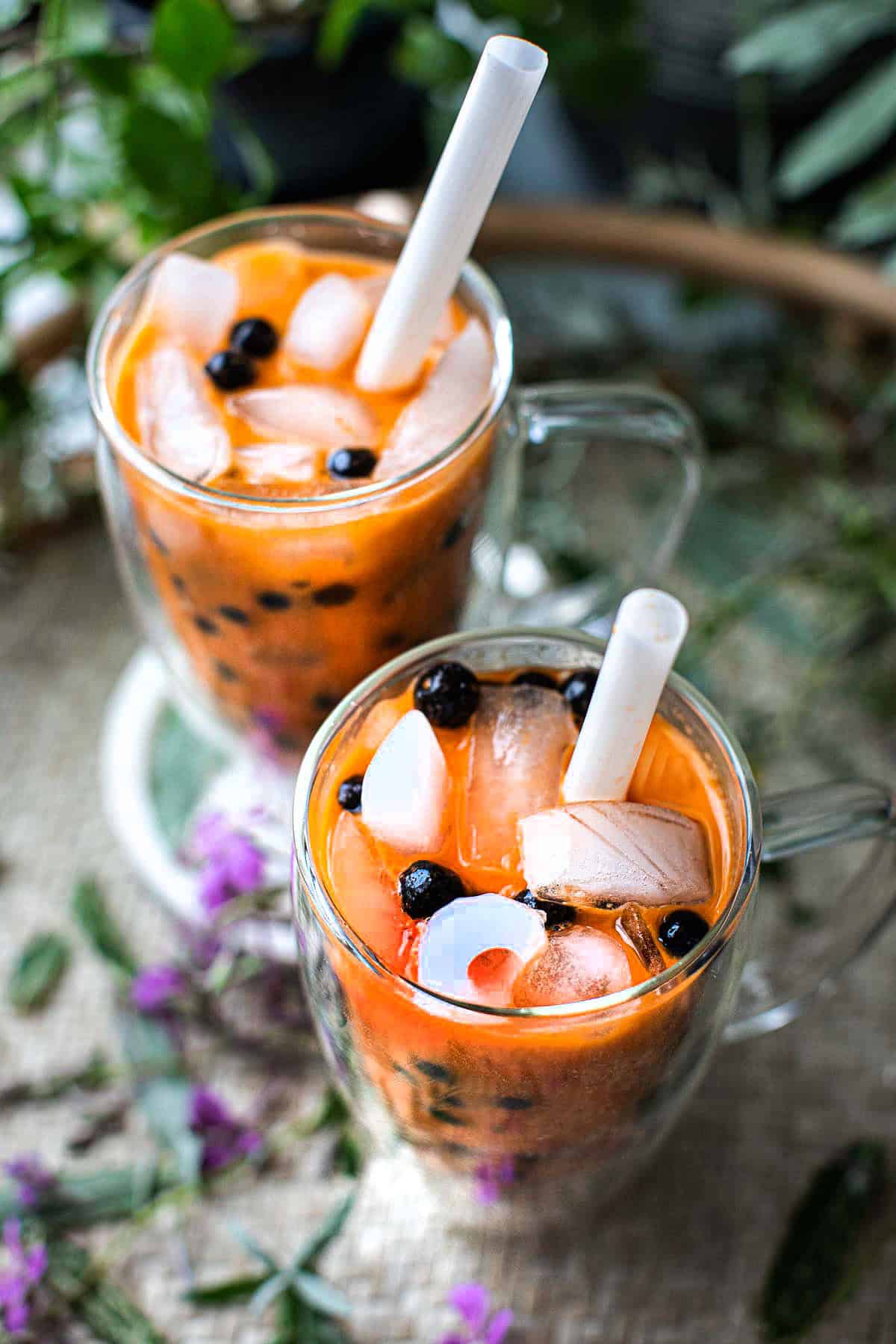 Thai tea boba pearls in two glass. 