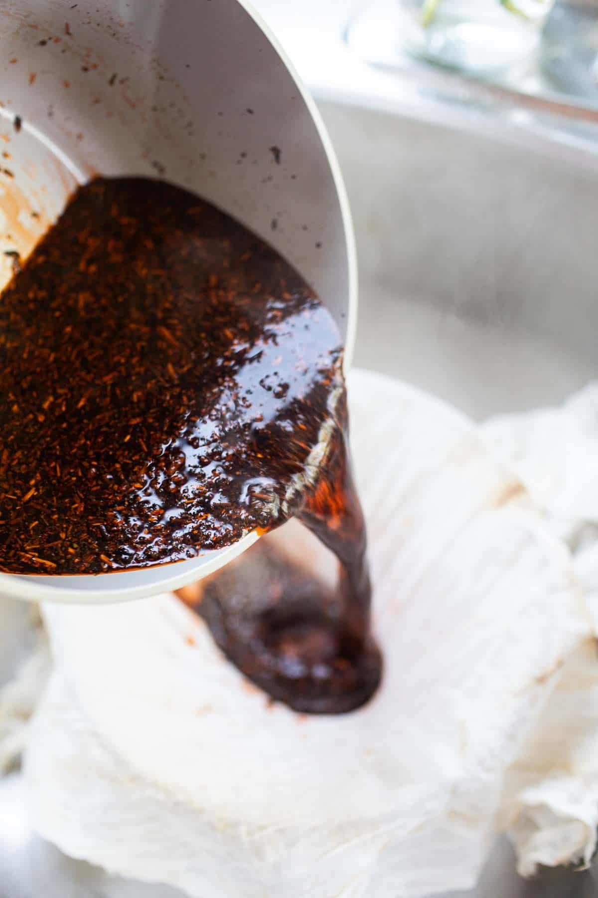  Thai tea mix pouring into a pot. 