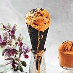 Thai tea ice cream in a cone.