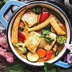 Thai vegetarian yellow curry with tofu in a pot.