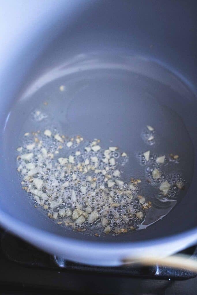 frying garlic in a pan. 