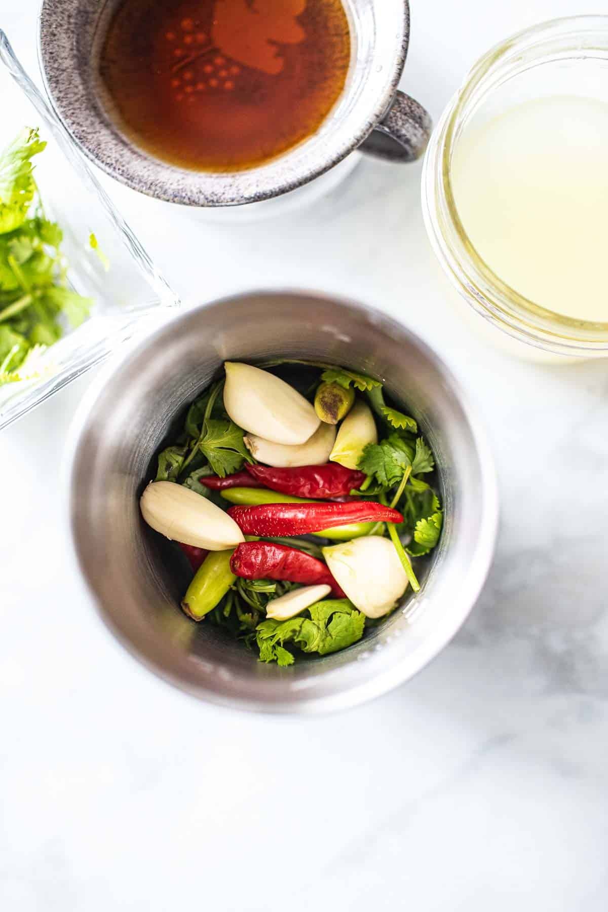 Chilis, galic and cilantro in a spice grinder. 