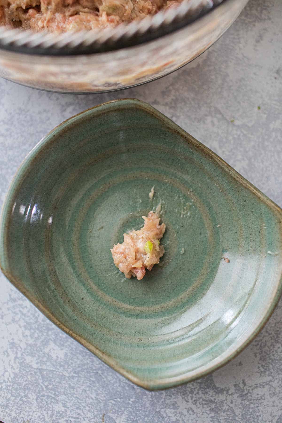 Dumpling paste in a green bowl.