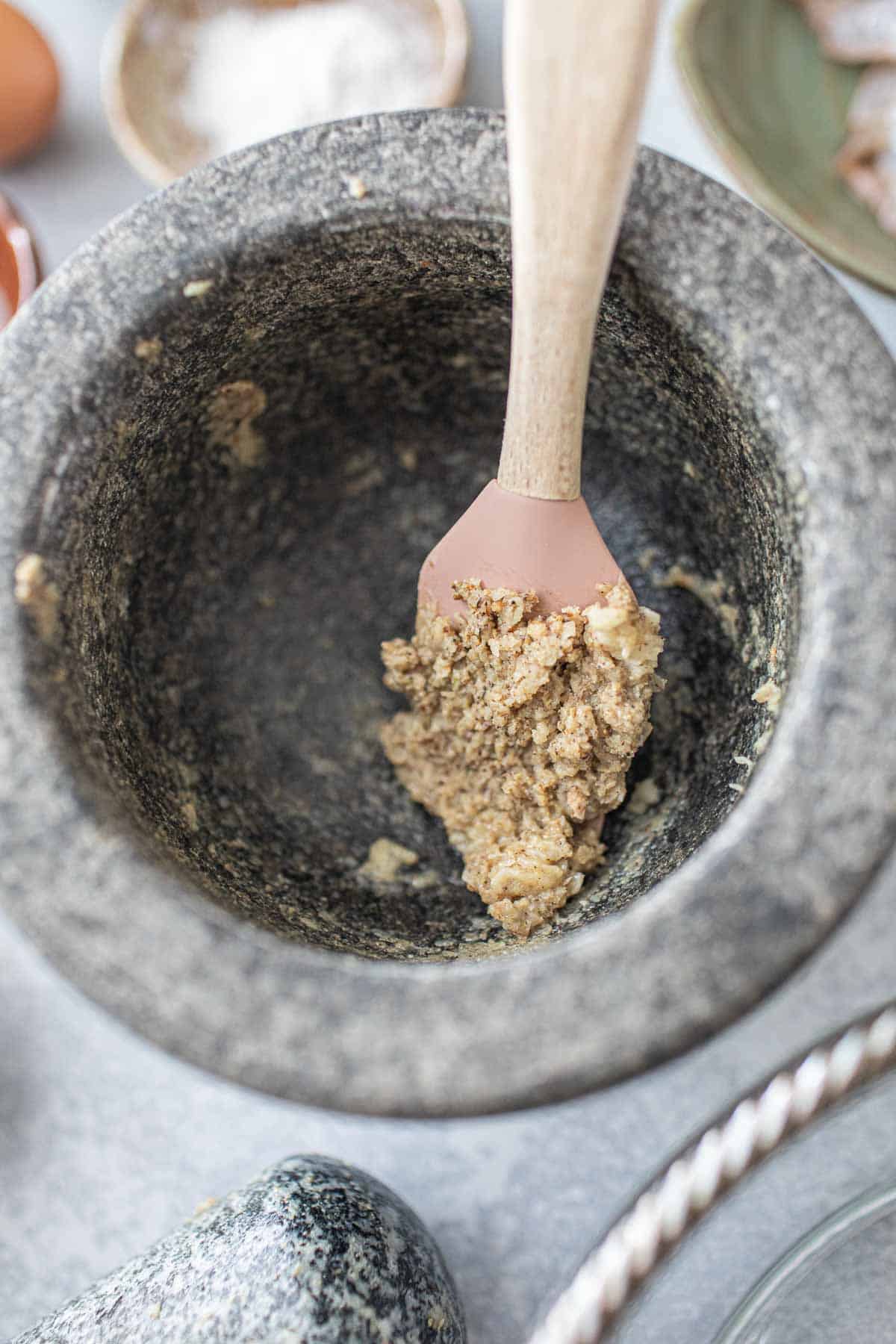 Garlic paste on a spatula in a mortar. 