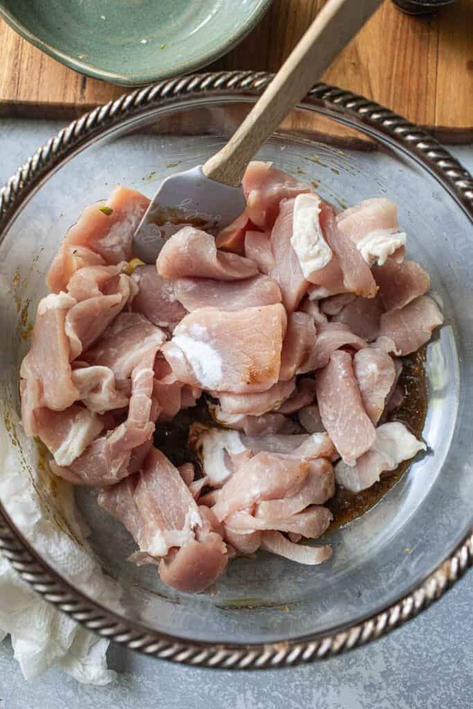 Pork marinated in a glass bowl. 