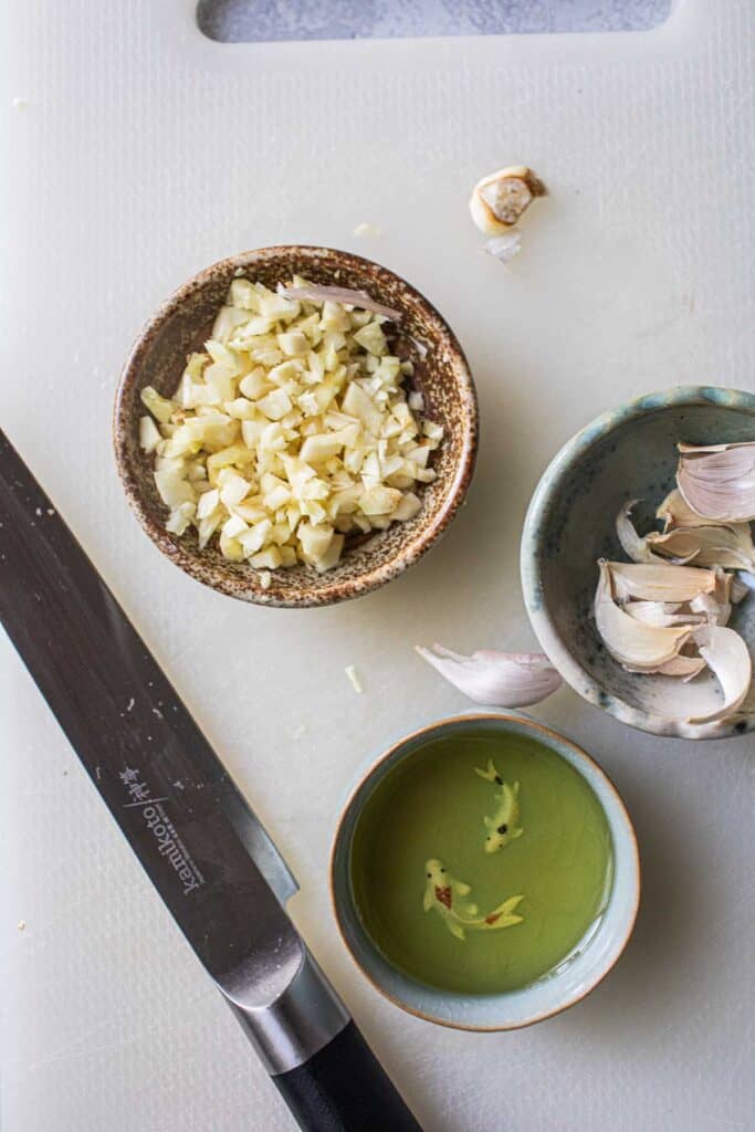 garlic and oil on a cutting board. 