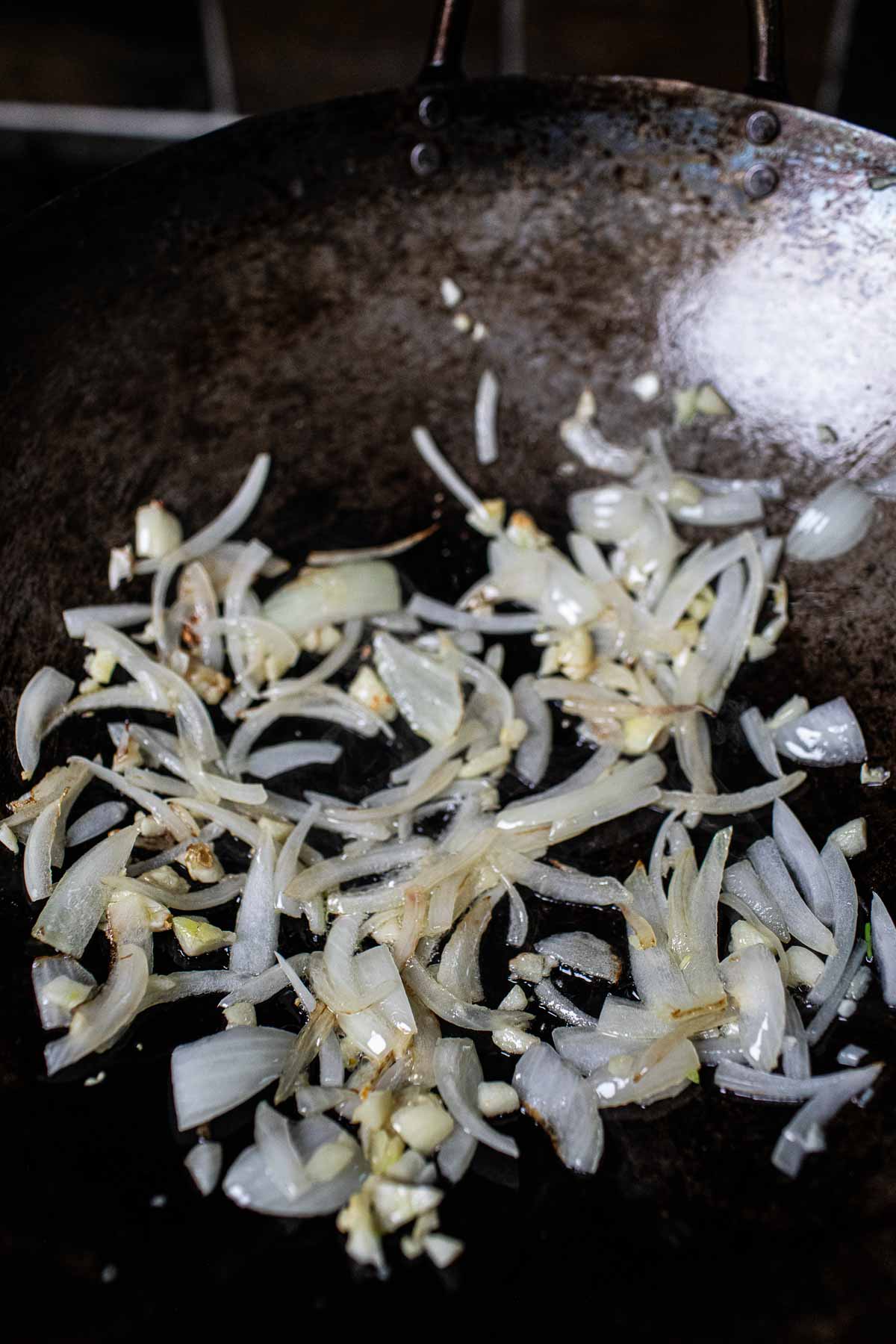 Garlic and onion frying in a wok.