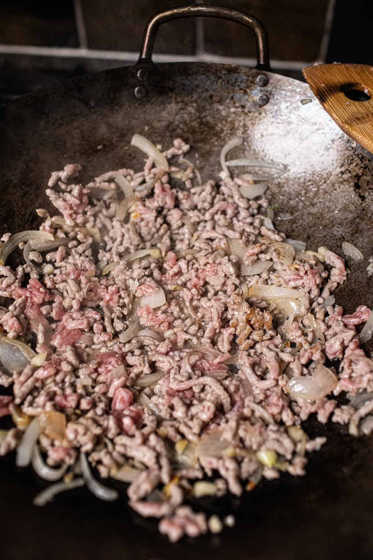 Pork cooking in wok.