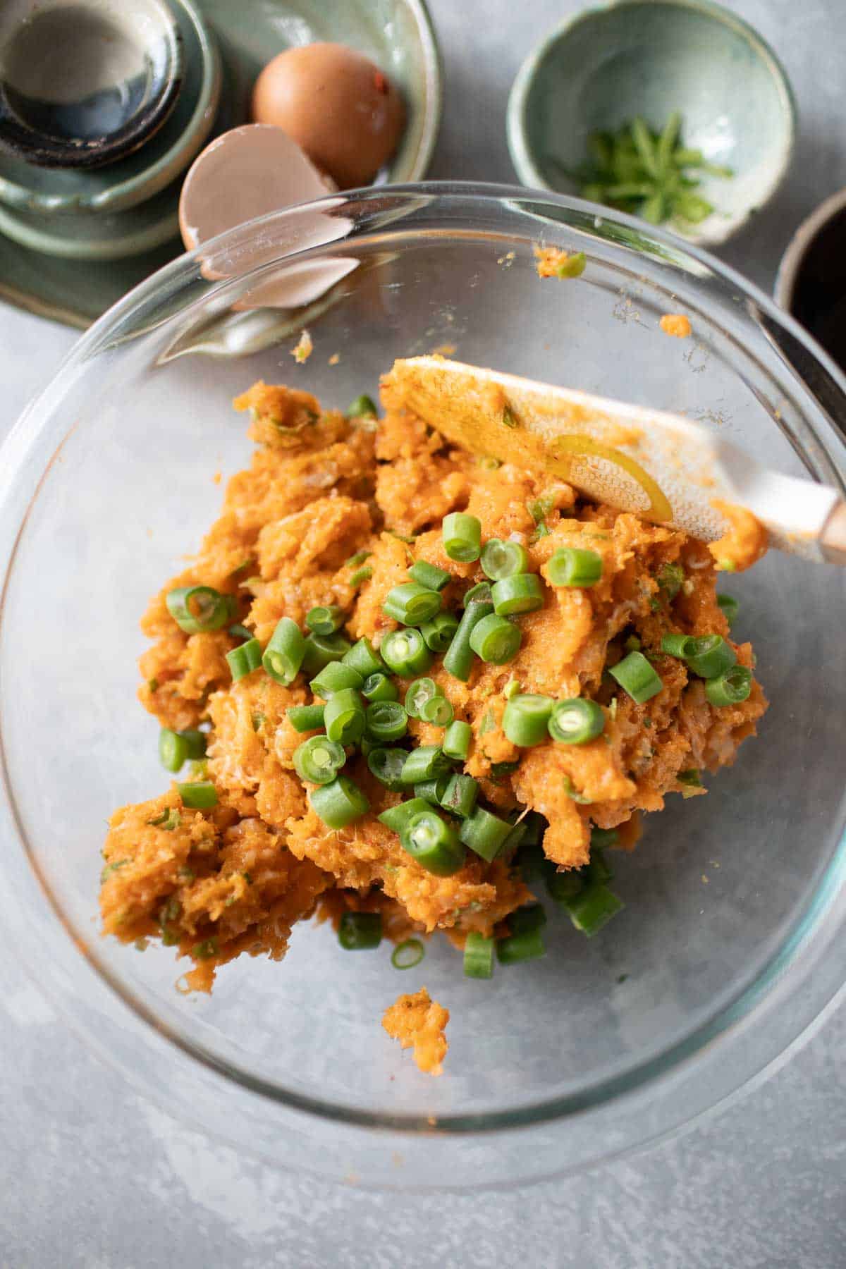 Thai fish cake paste with green beans in a glass bowl.