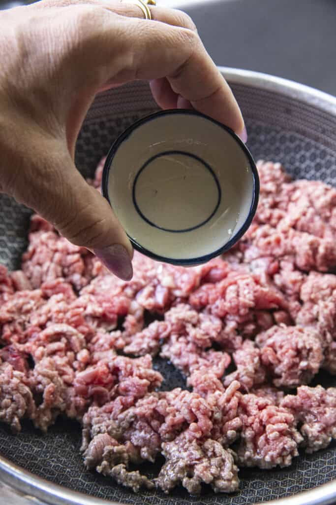 Water for pouring over pan of Thai Beef Laab.