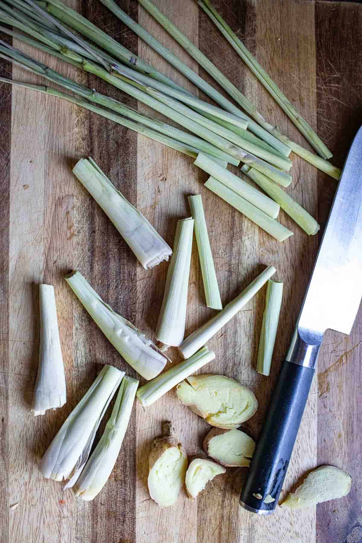 Bruised Lemongrass and ginger on a cutting board. 