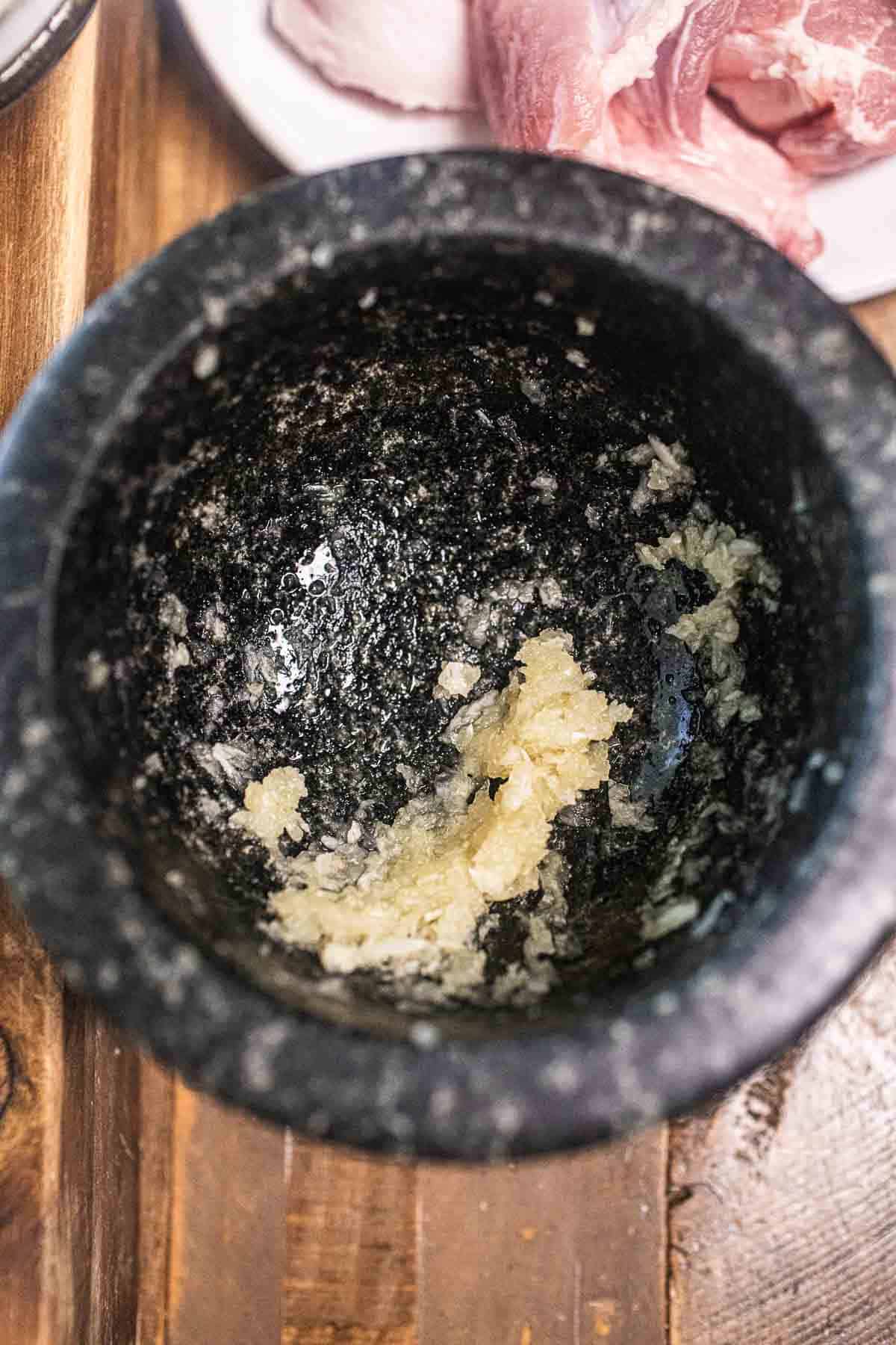 pounded garlic on mortar.