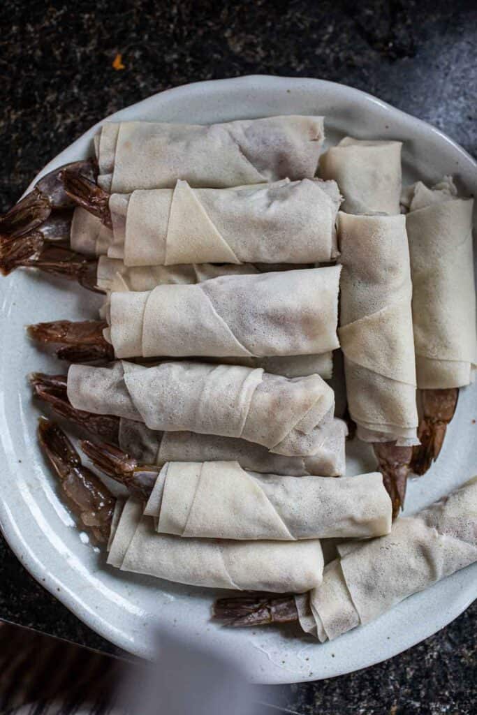 un cooked Thai shrimp rolls on a platter.