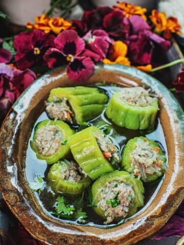 stuffed Bitter melon pieces in a bowl of broth.