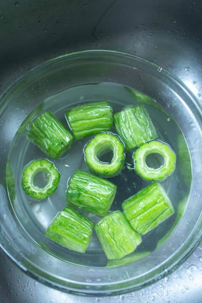 Bitter melon in a bowl of water.
