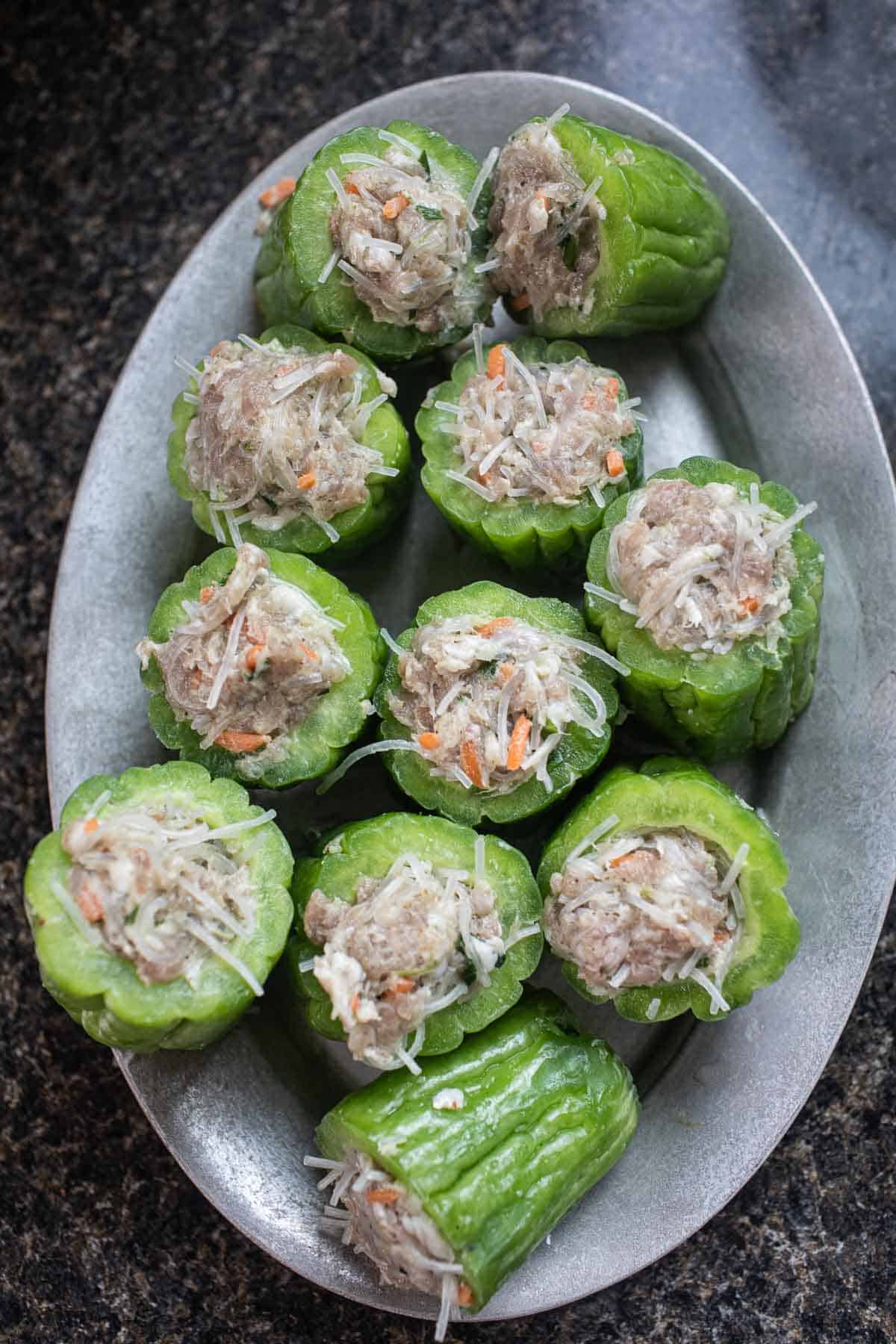 Stuffed bitter melon pieces on a plate. 