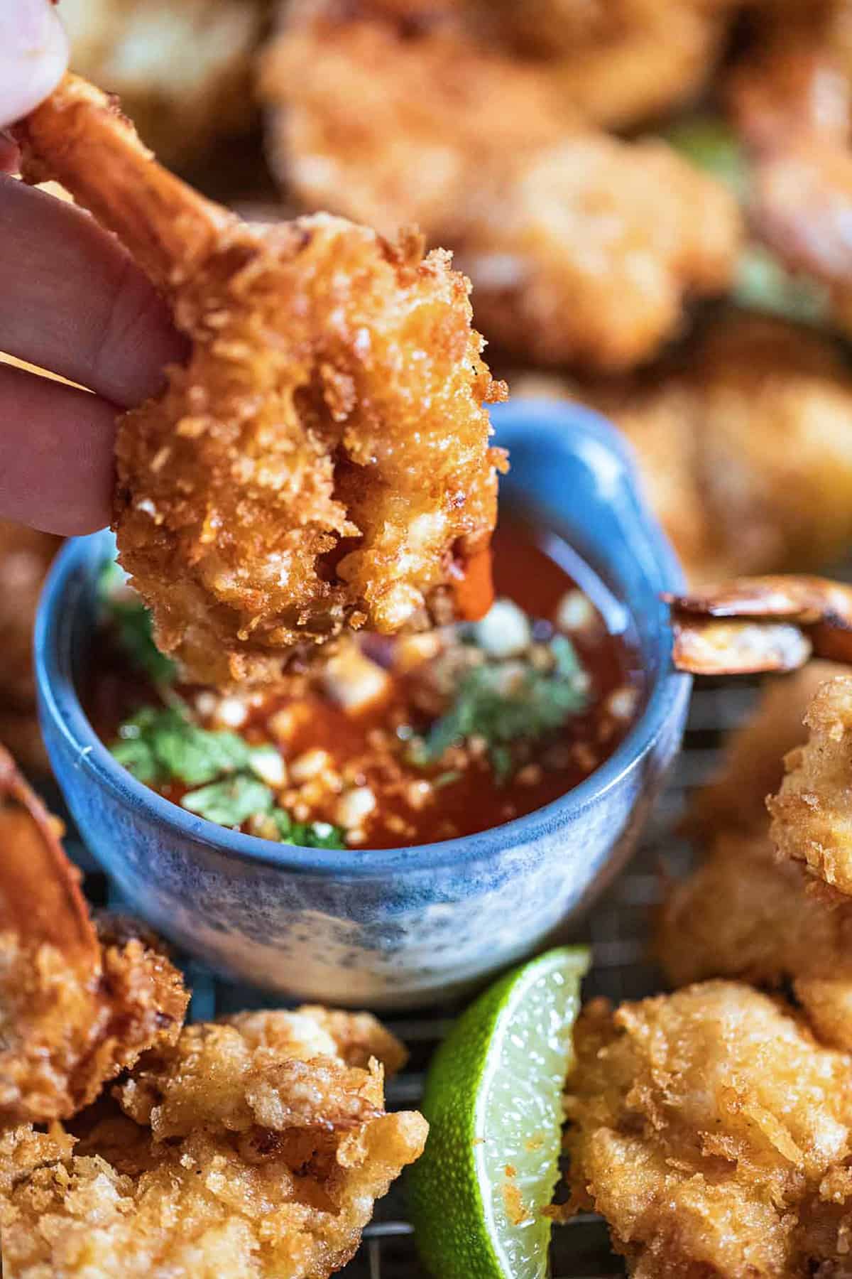 fried butterfly shrimp in a dipping bowl. 